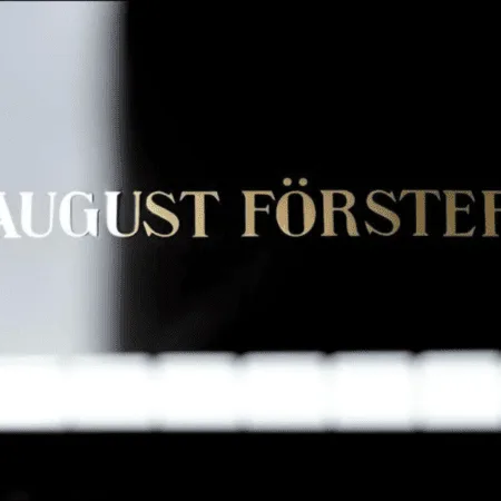 Close-up of the name 'August Förster' on a piano.