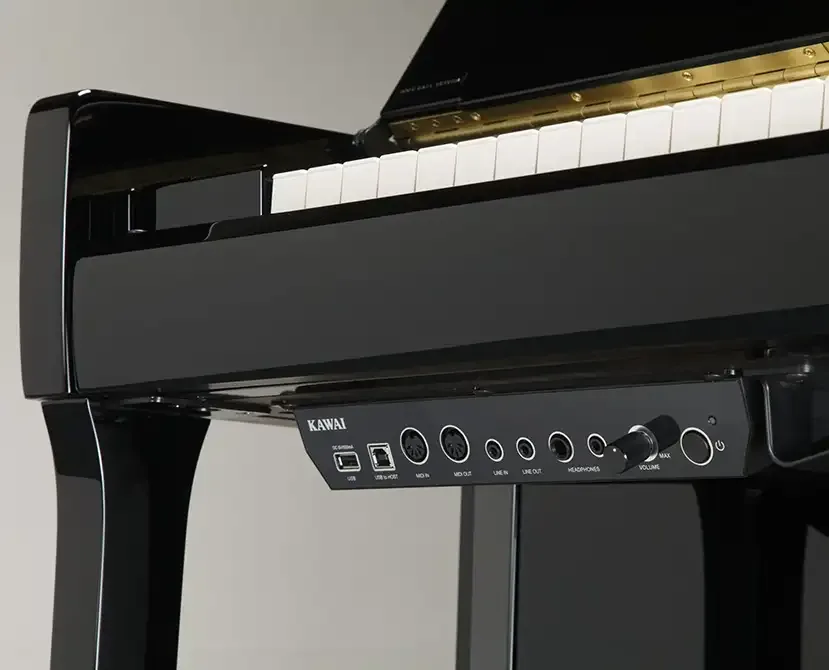 Close-up of piano keys with audio output jacks.
