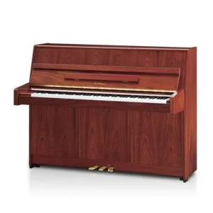 A classic upright wooden piano with three pedals and white and black keys.
