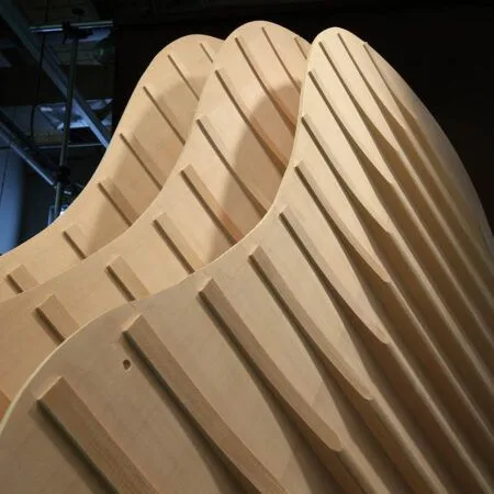 Close-up of curved wooden slats forming a modern architectural design.
