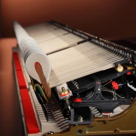 Close-up of piano strings and internal mechanics inside a grand piano.