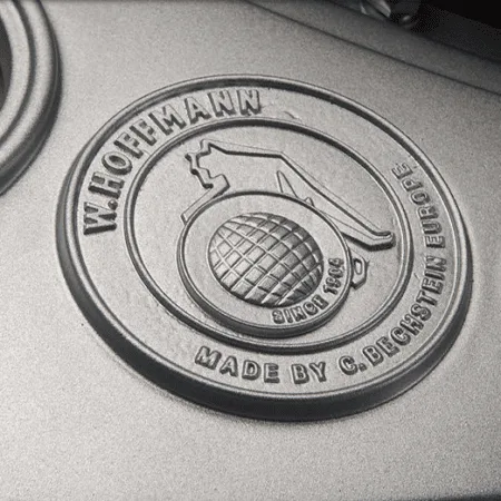 Close-up of a vintage-style metal emblem with a grenade design.