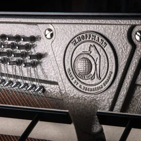 Close-up of a metallic BBQ grill with embossed logo and serial number.