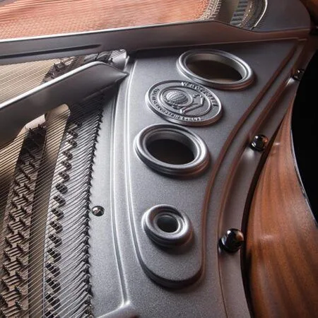 Close-up of vintage car interior showing door handle and speaker grille.