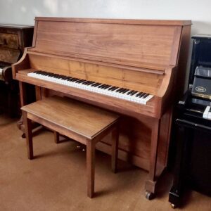 Classic upright wooden piano with matching bench in a cozy room.