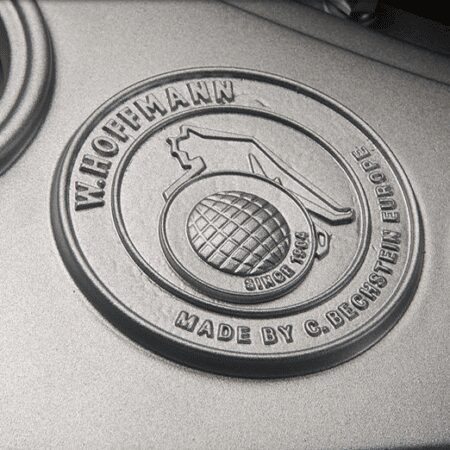 Close-up of a vintage-style metal emblem with a grenade design.