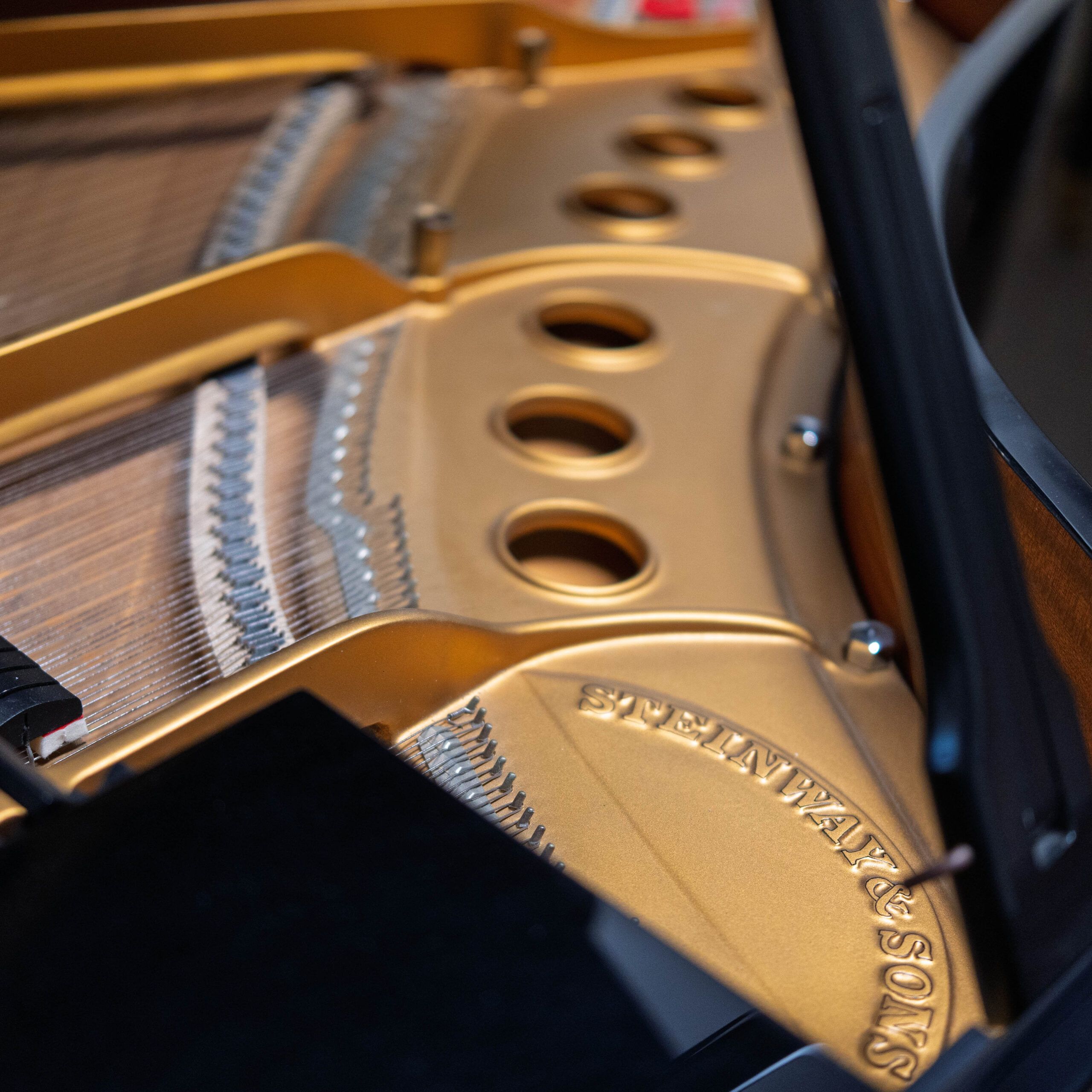 Close-up of a Steinway & Sons grand piano interior showing strings and frame.